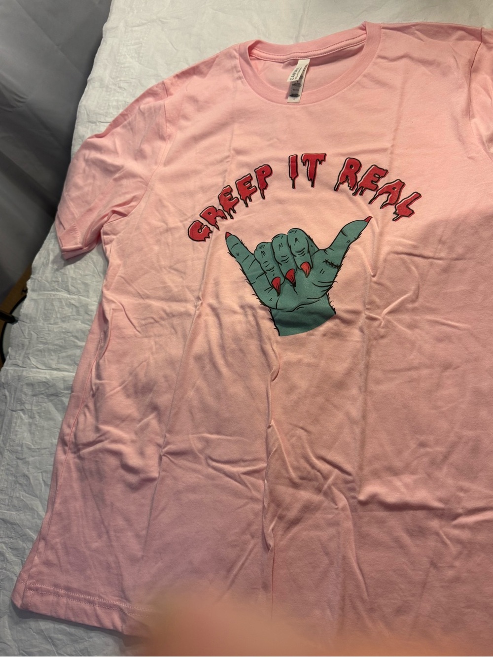 Bella Canvas Pink Tee with Green Hand Graphic and Red Lettering
